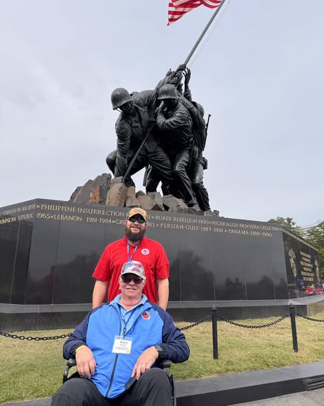 The Iwo Jima flag-raising sculpture behind our veterans.