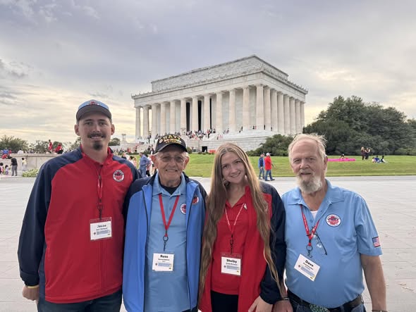 A group gathers in front of the Lincoln Memorial.