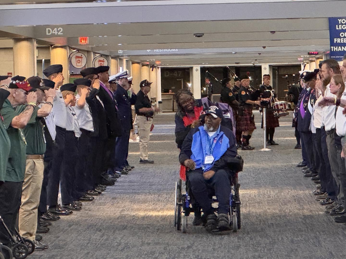 A veteran welcomed home by a corridor of saluting supporters.
