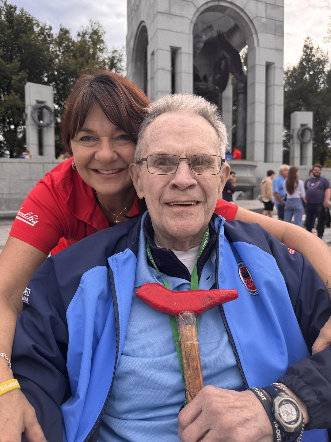 A veteran and guardian with the World War II Memorial’s pavilion behind them.
