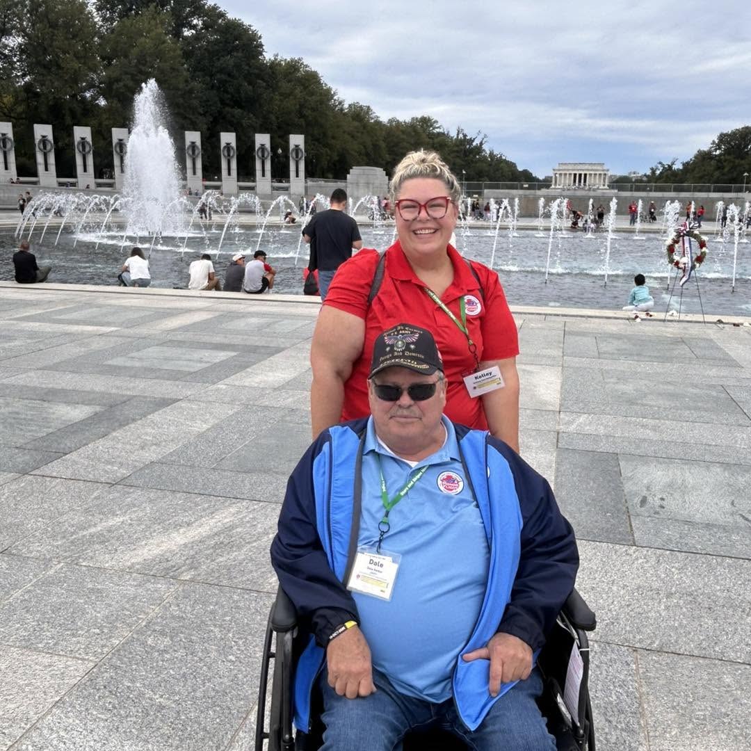 An Alpha veteran and guardian beside the World War II Memorial fountains.