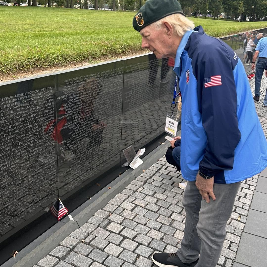 An Alpha veteran pauses at the Vietnam Veterans Memorial wall.