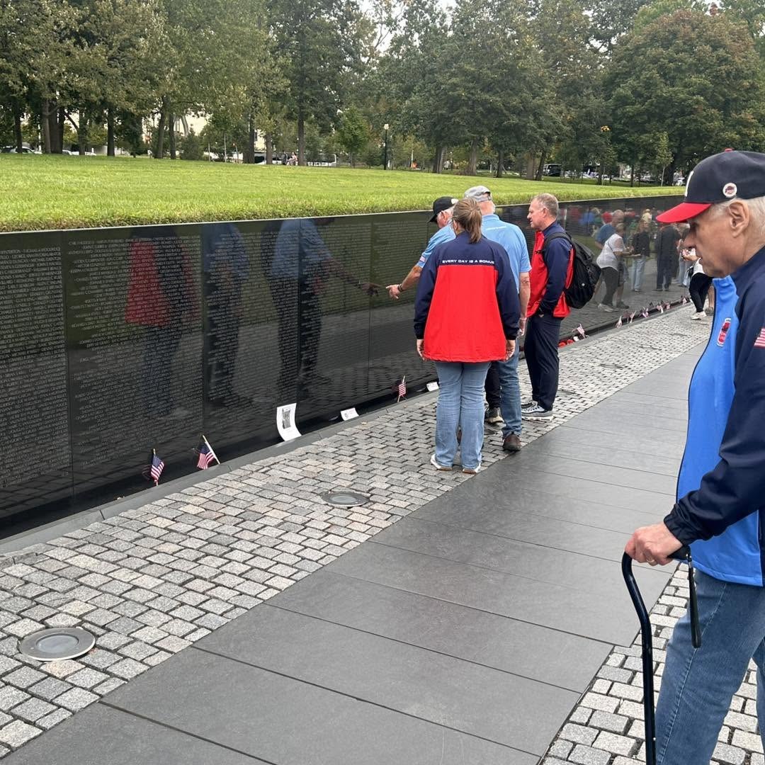 Alpha veterans take time for reflection along the memorial wall.