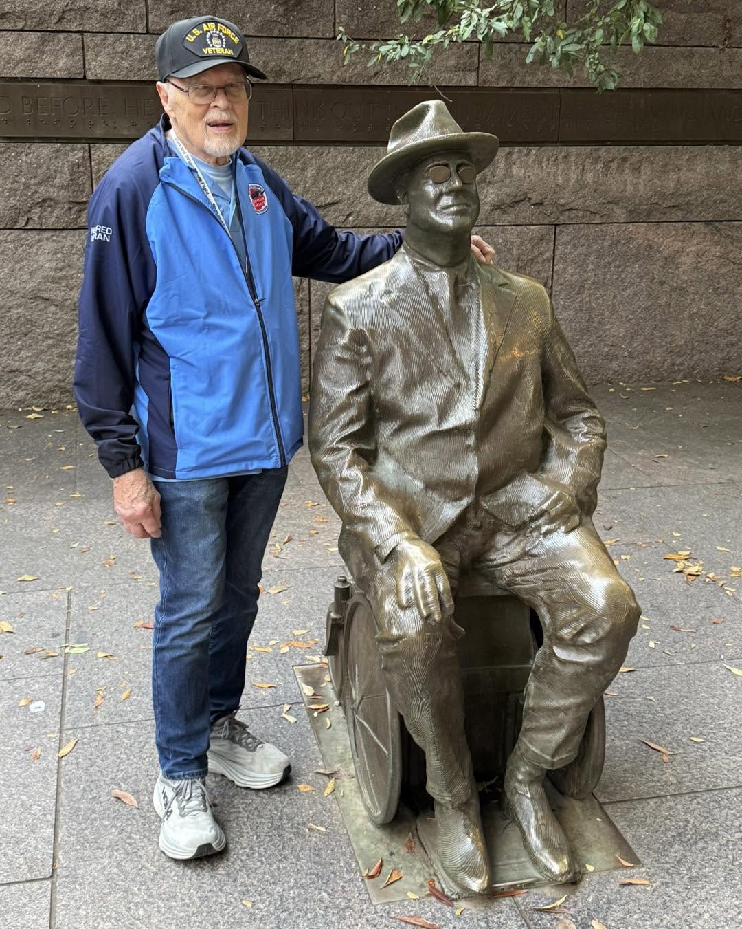 A veteran beside President Roosevelt and Fala at the FDR Memorial.